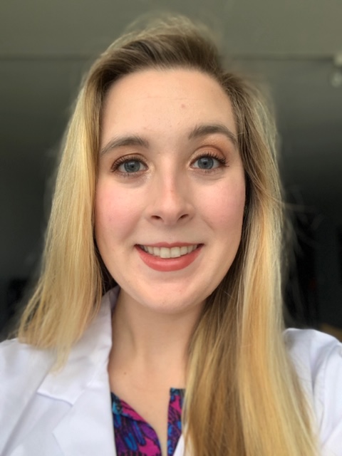 A person smiling for the camera
Description automatically generated